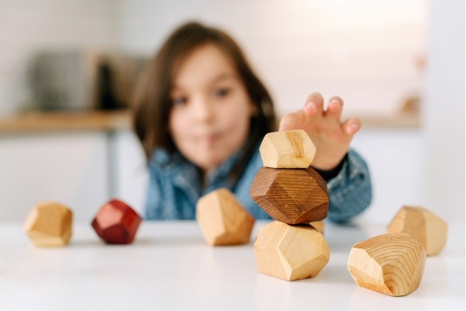 child playing with wooden blocks